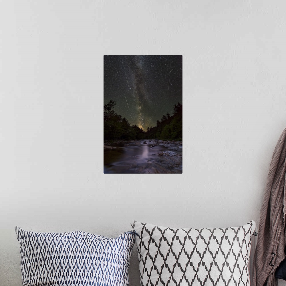A bohemian room featuring A photograph of a wilderness landscape under a night sky.