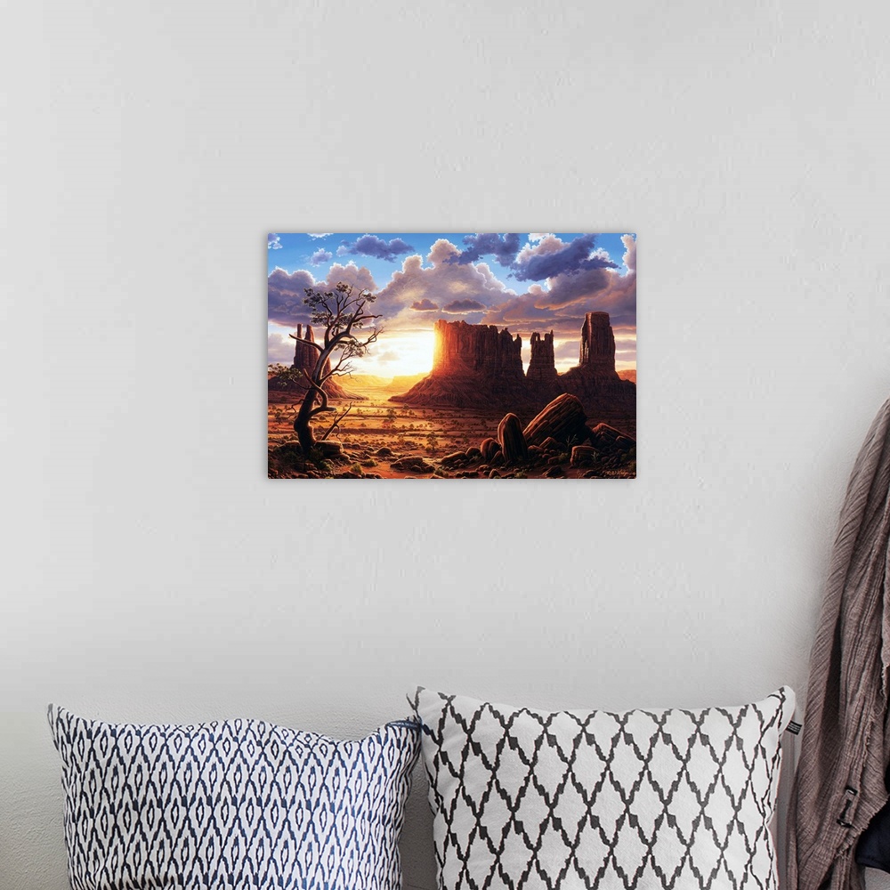A bohemian room featuring The sun setting behind the rock formations of Monument Valley.