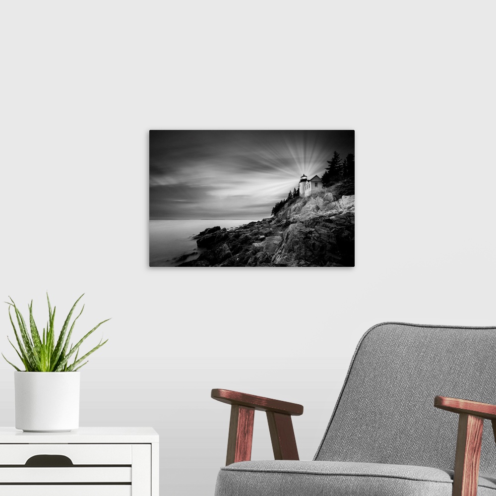 A modern room featuring A black and white photograph of a lighthouse on the coast of Maine.