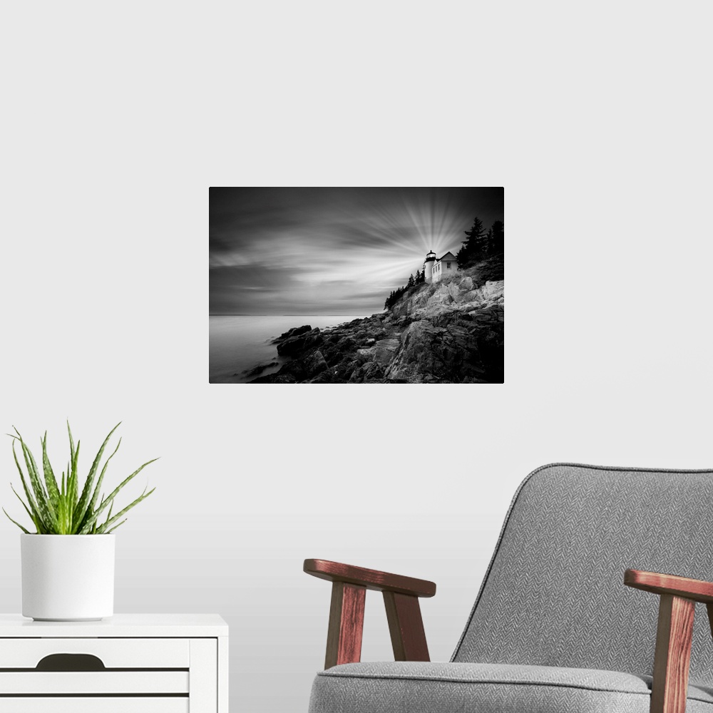 A modern room featuring A black and white photograph of a lighthouse on the coast of Maine.