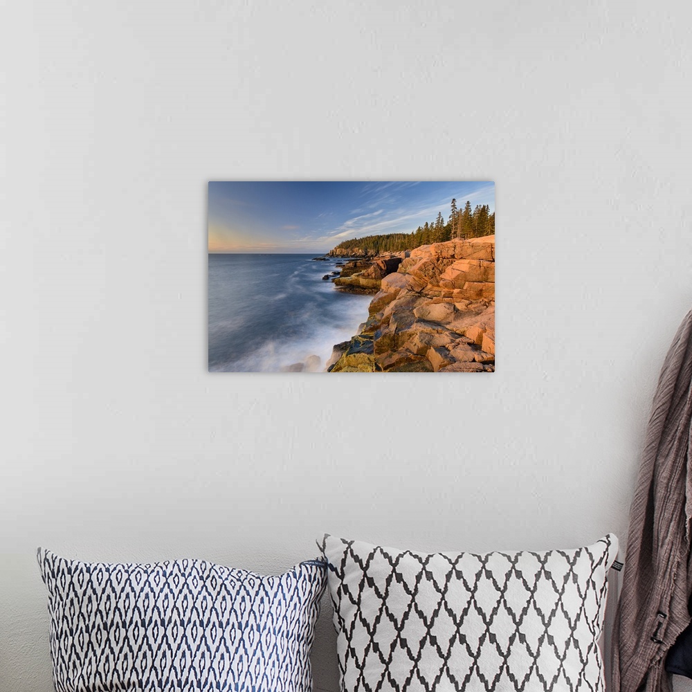 A bohemian room featuring A photograph of a rocky coastline in Maine.