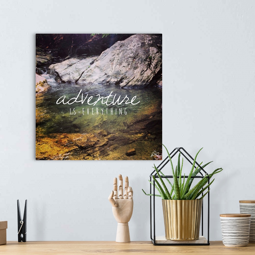 A bohemian room featuring Motivational sentiment against photograph of a forest stream.