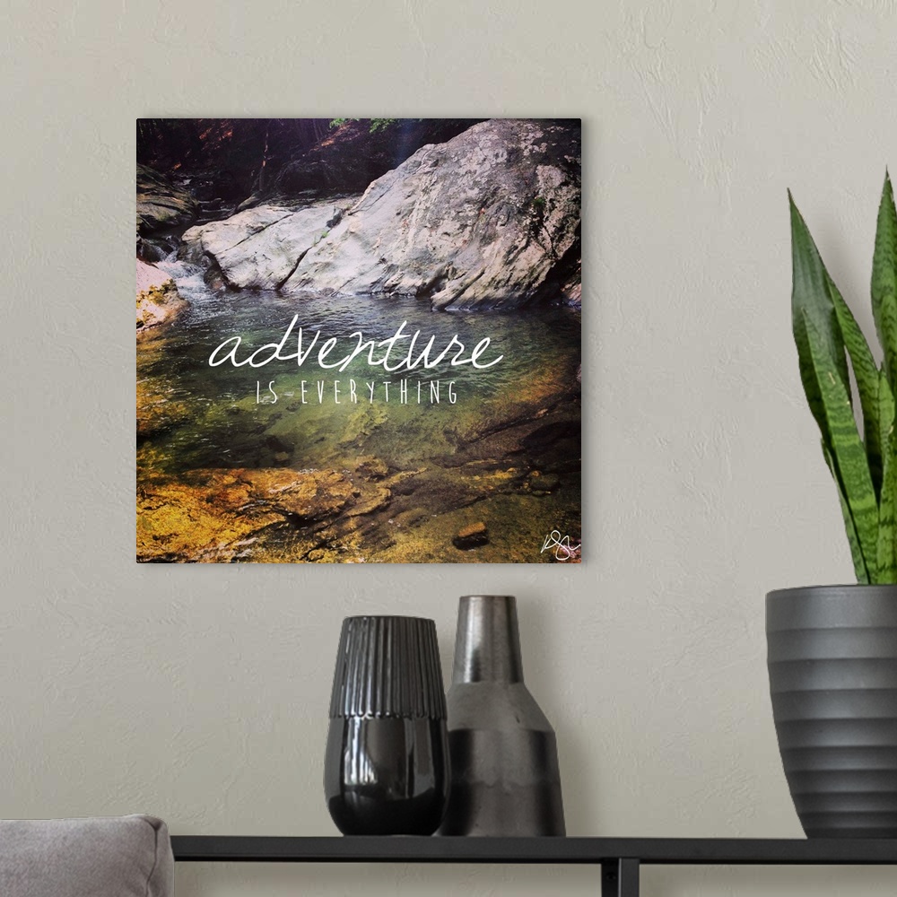 A modern room featuring Motivational sentiment against photograph of a forest stream.