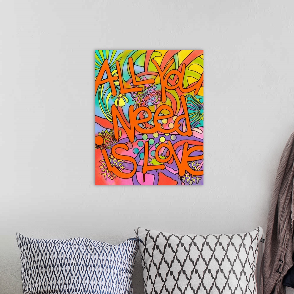 A bohemian room featuring "All You Need is Love" Written in orange bubble letters with paint drips on top of a colorful bac...