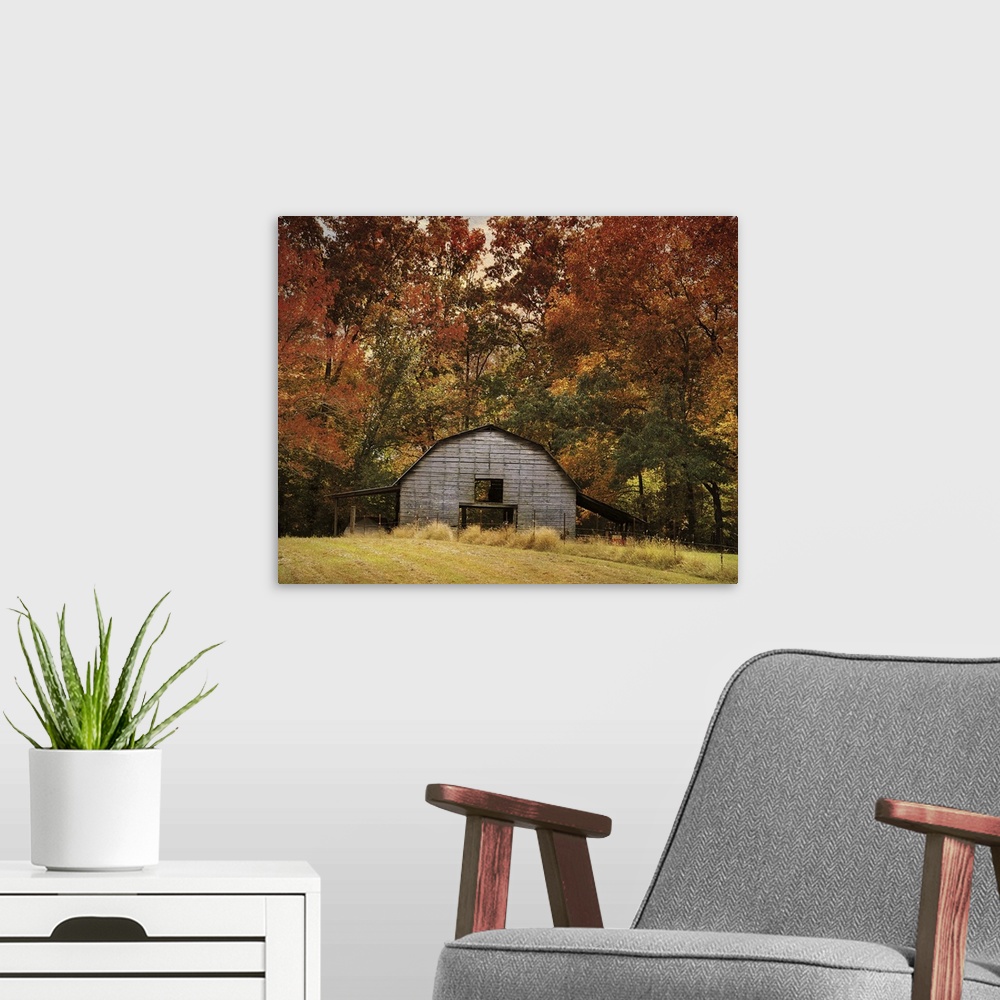 A modern room featuring Fine art photo of a round barn in a forest in the fall.