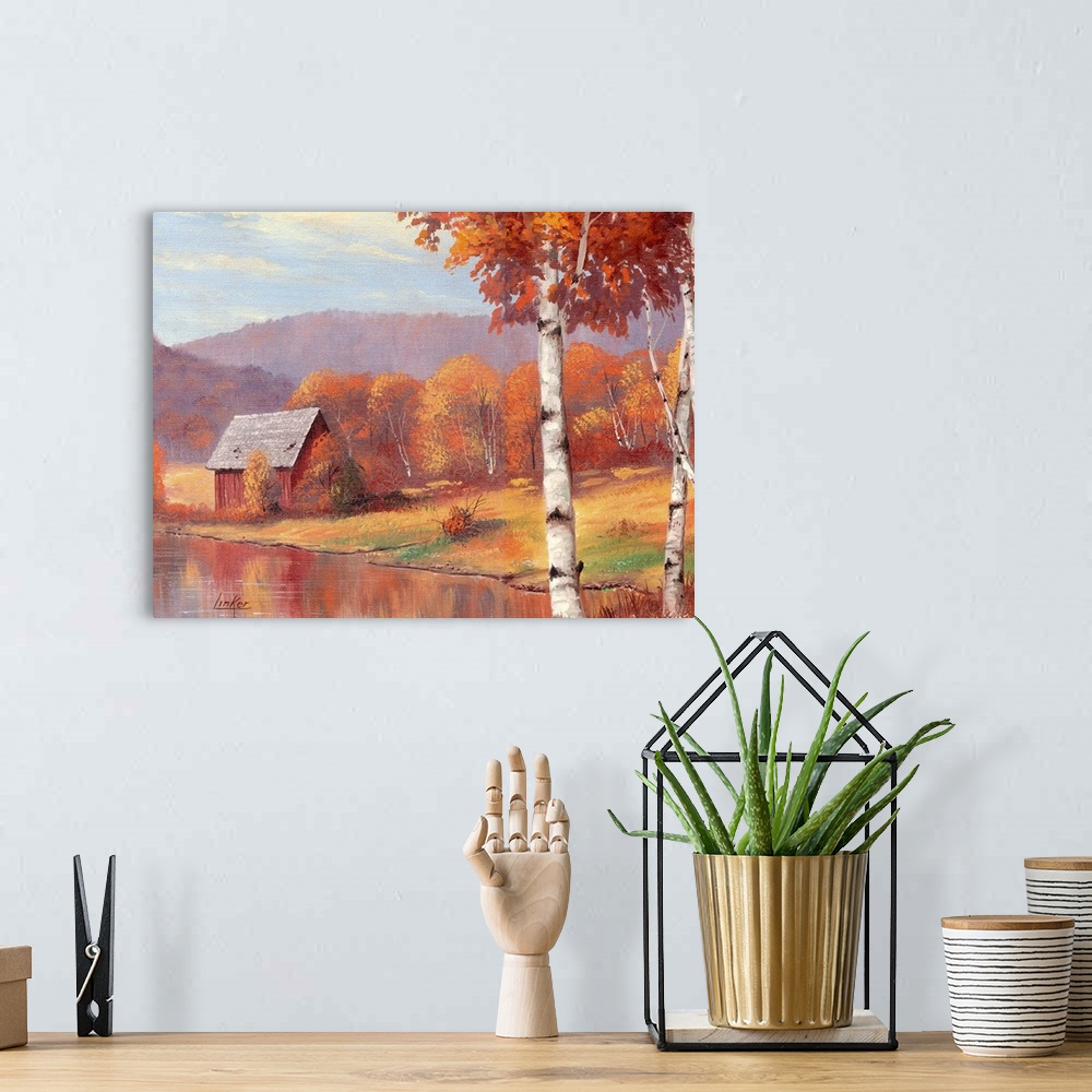 A bohemian room featuring Shack by pond in front of mountain range and autumn birch trees.