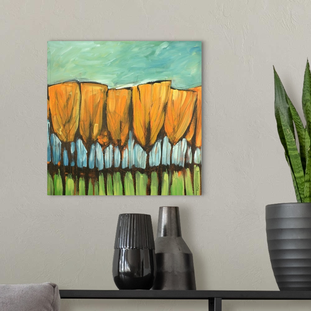 A modern room featuring Contemporary painting of a row of trees in fall colors.