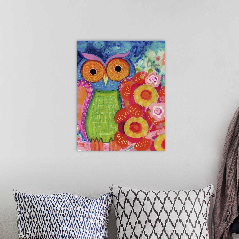 A bohemian room featuring An owl with large orange eyes sitting next to red flowers.
