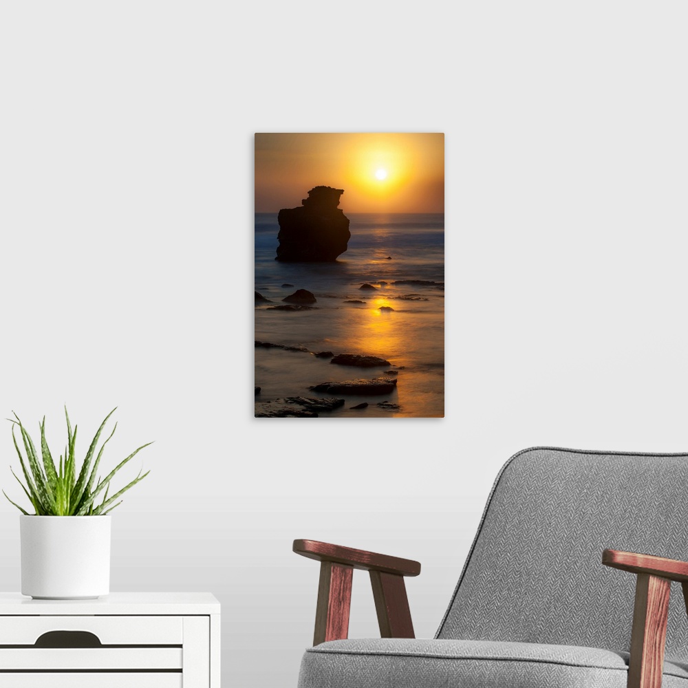 A modern room featuring Sunset, rocks, ocean, color photography