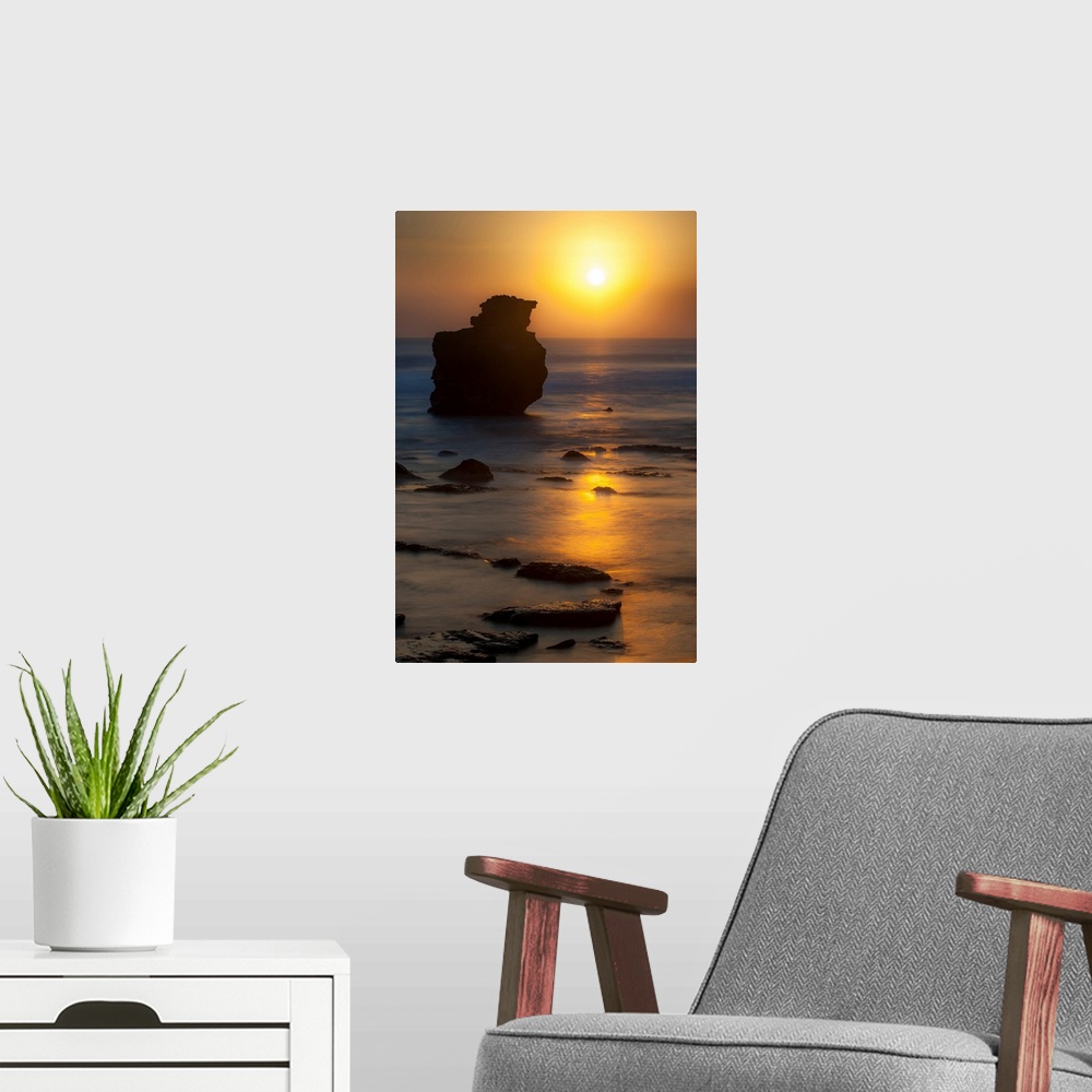 A modern room featuring Sunset, rocks, ocean, color photography