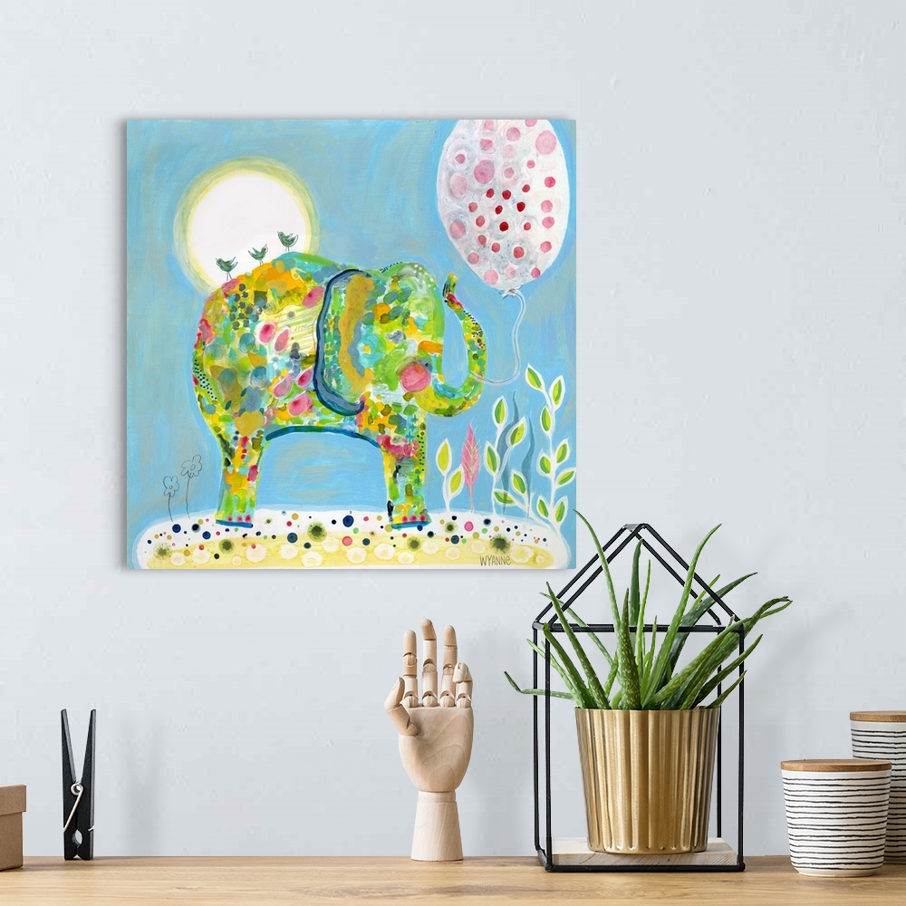 A bohemian room featuring An elephant in blue and green under the sun with a pink balloon.
