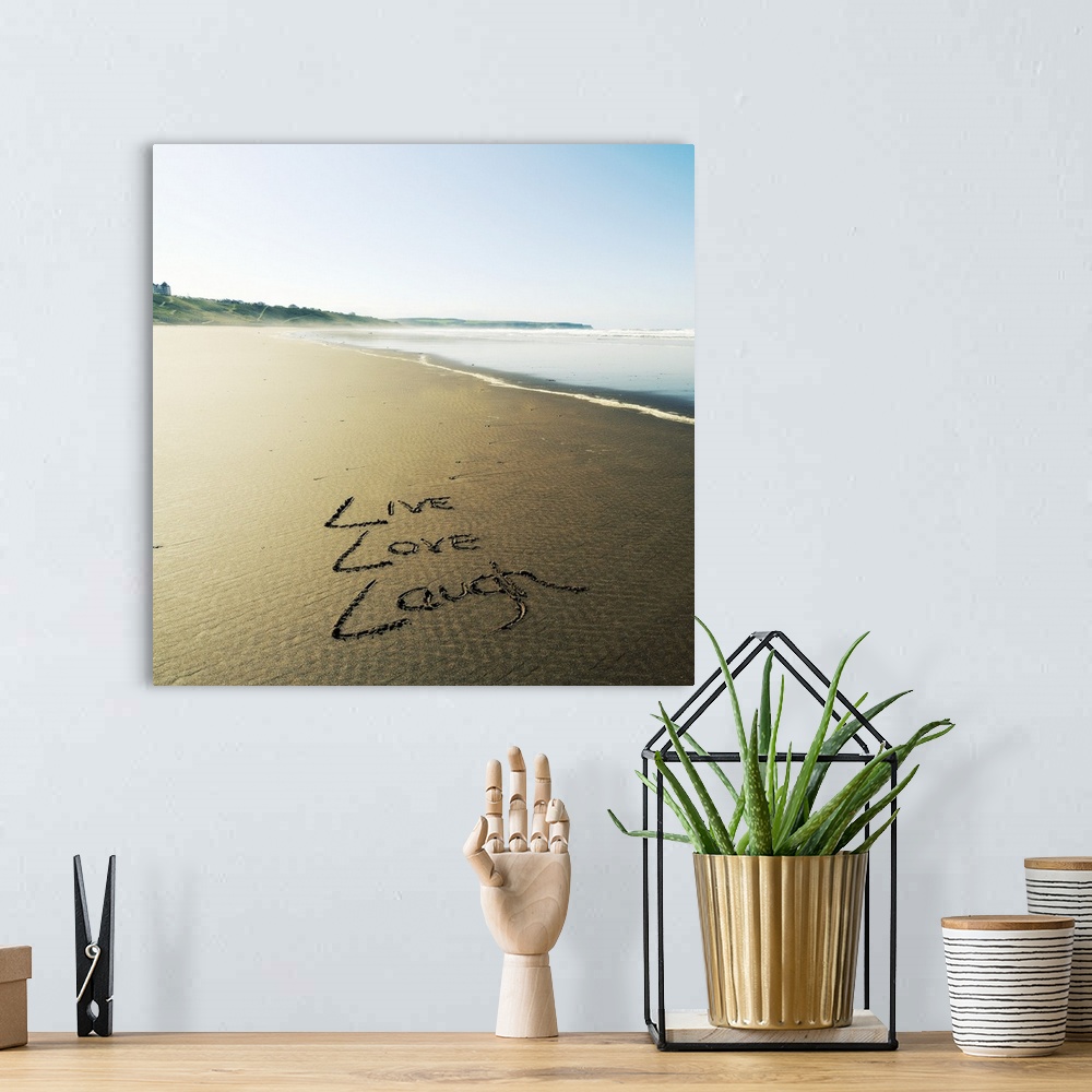 A bohemian room featuring Photo of these words written in the sand: Live, Love, Laugh.