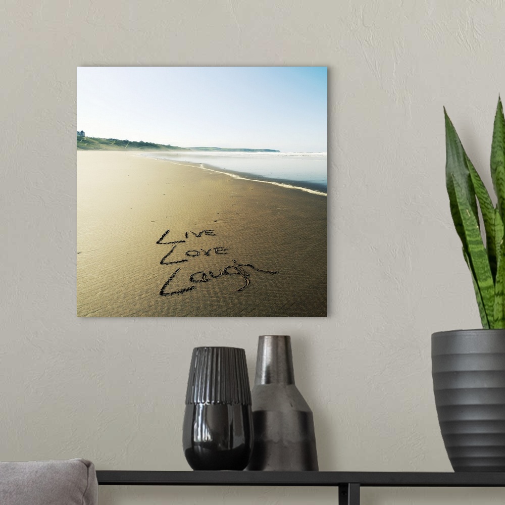 A modern room featuring Photo of these words written in the sand: Live, Love, Laugh.