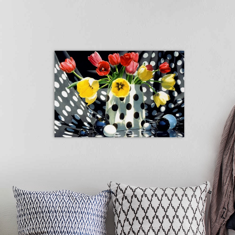A bohemian room featuring Contemporary vivid realistic still-life painting of red and yellow tulips sitting in a polka dott...