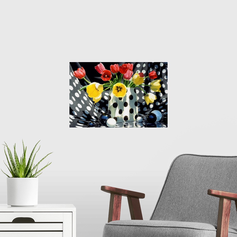 A modern room featuring Contemporary vivid realistic still-life painting of red and yellow tulips sitting in a polka dott...