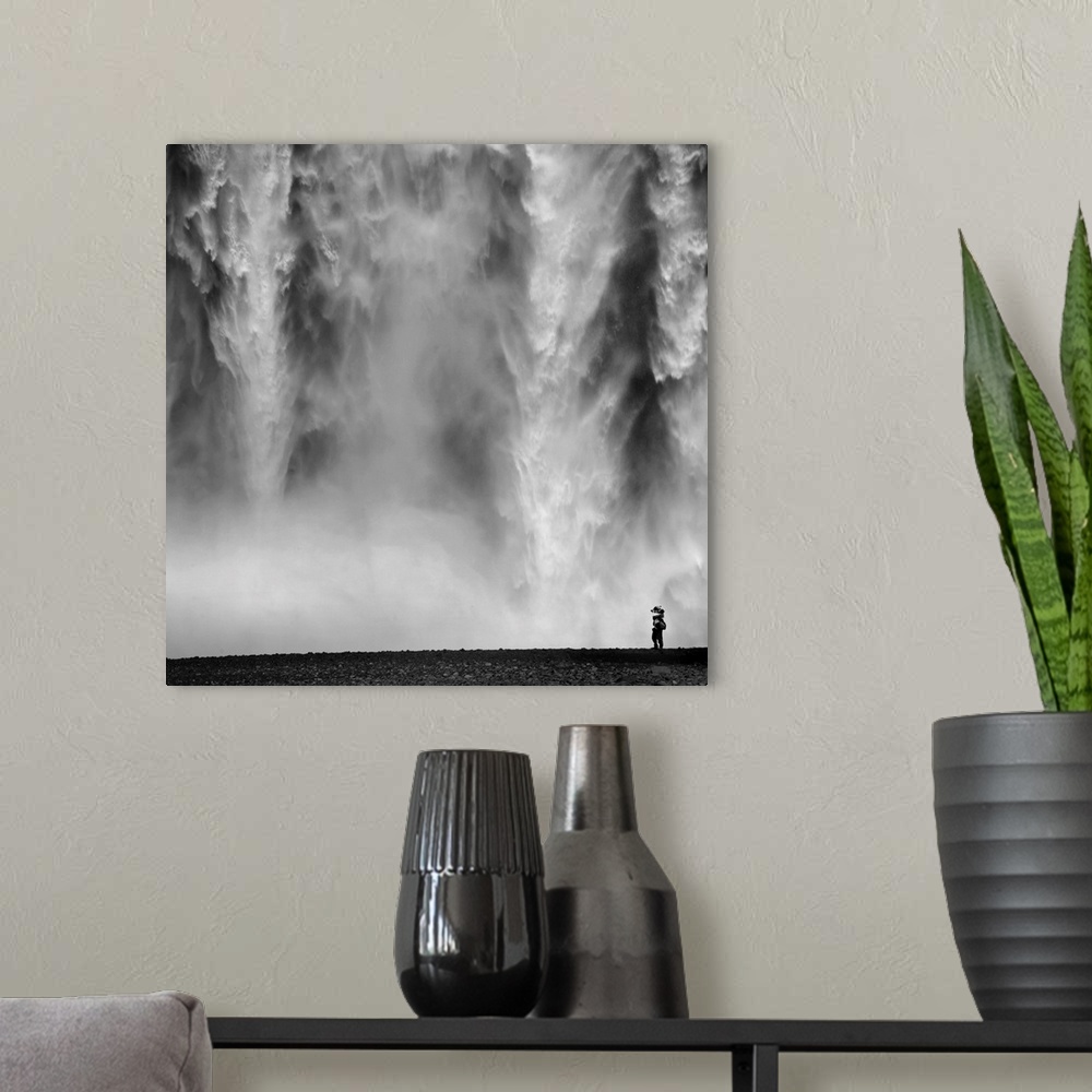 A modern room featuring Black and White Photo of waterfall with person