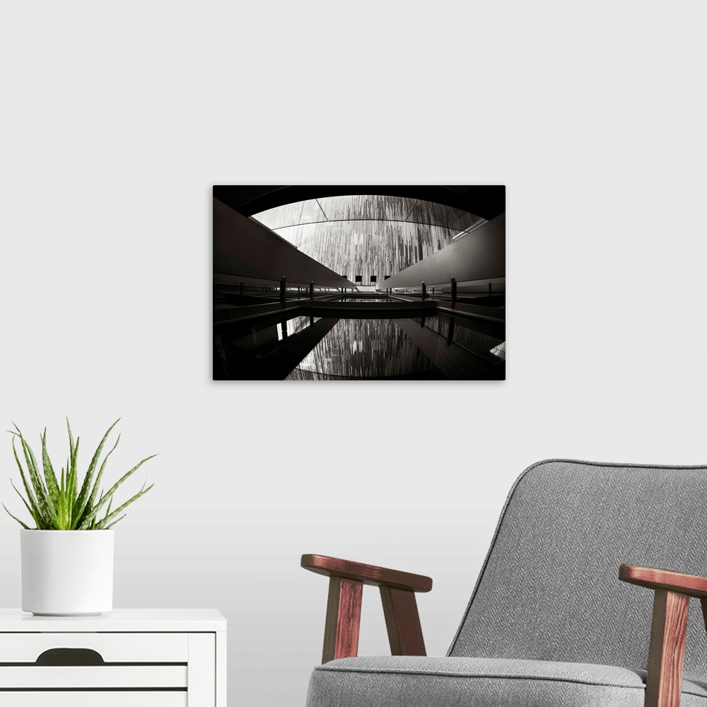 A modern room featuring A black and white photograph of an architectural structure.