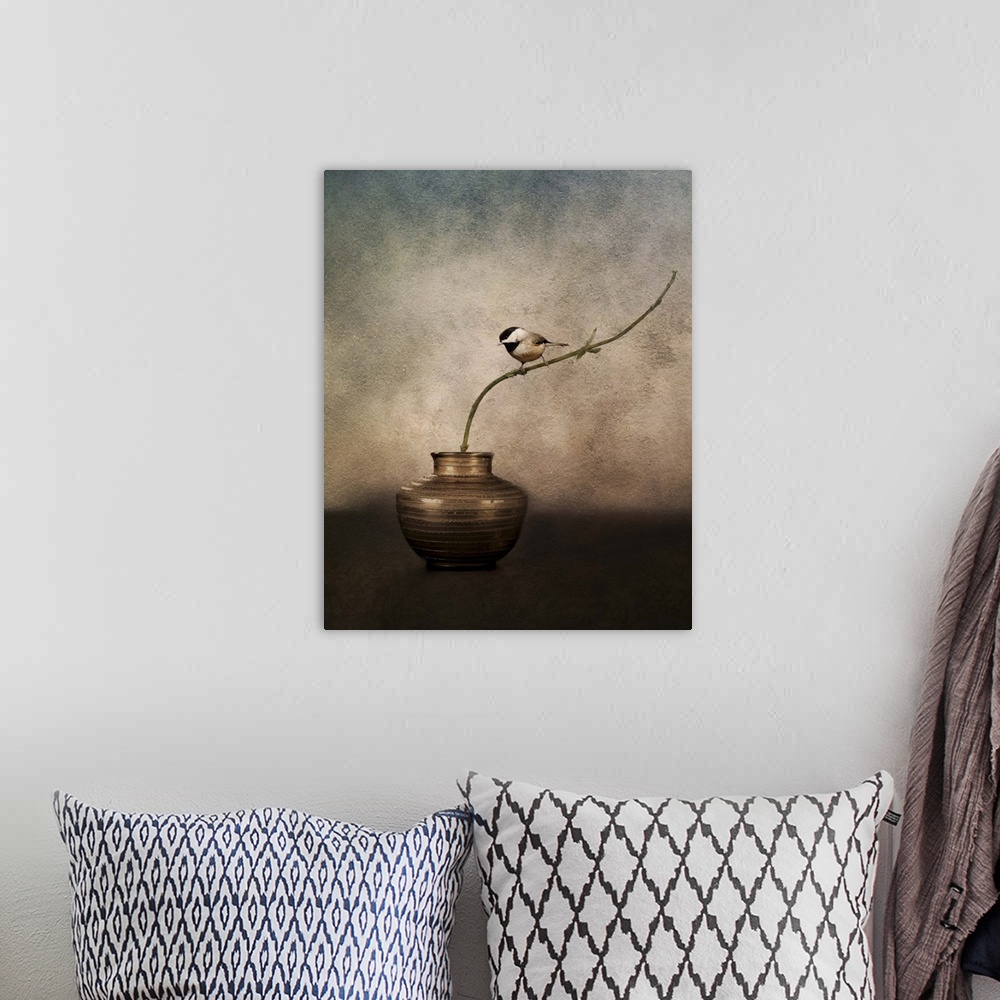 A bohemian room featuring A Black-capped Chickadee perched on a twig in a vase.