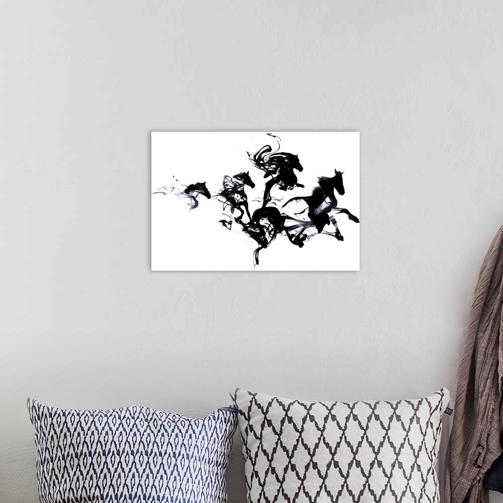 A bohemian room featuring Contemporary artwork of black ink blotches creating the shape of galloping horses.