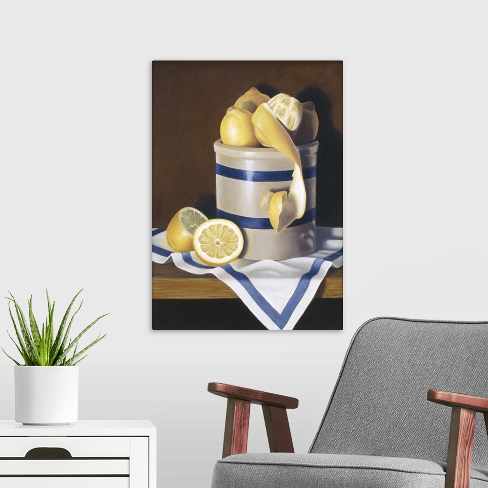 A modern room featuring Contemporary vivid still-life artwork of lemons sitting in a white and blue striped ceramic conta...