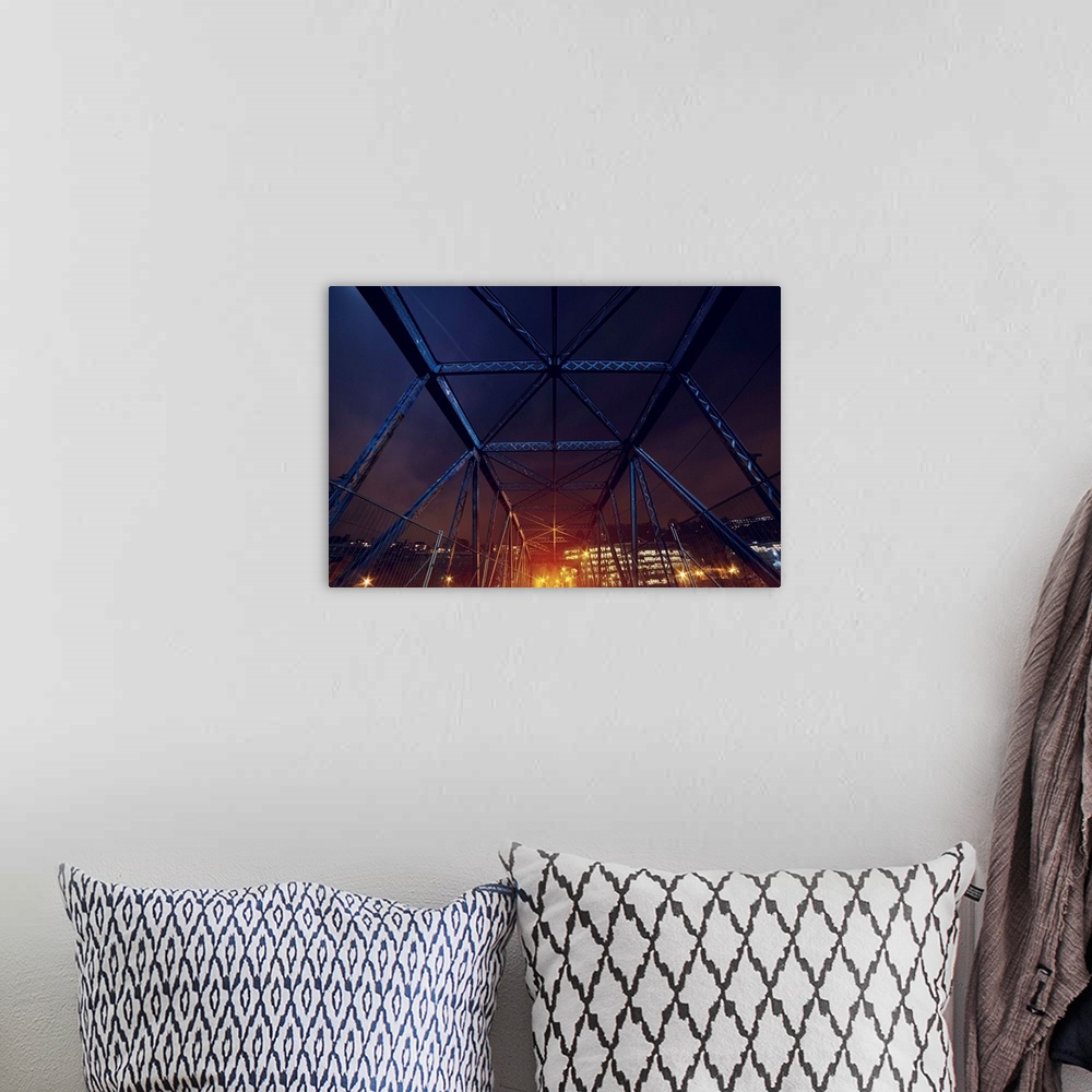 A bohemian room featuring An HDR photograph of an urban area seen through the frame of a bridge.