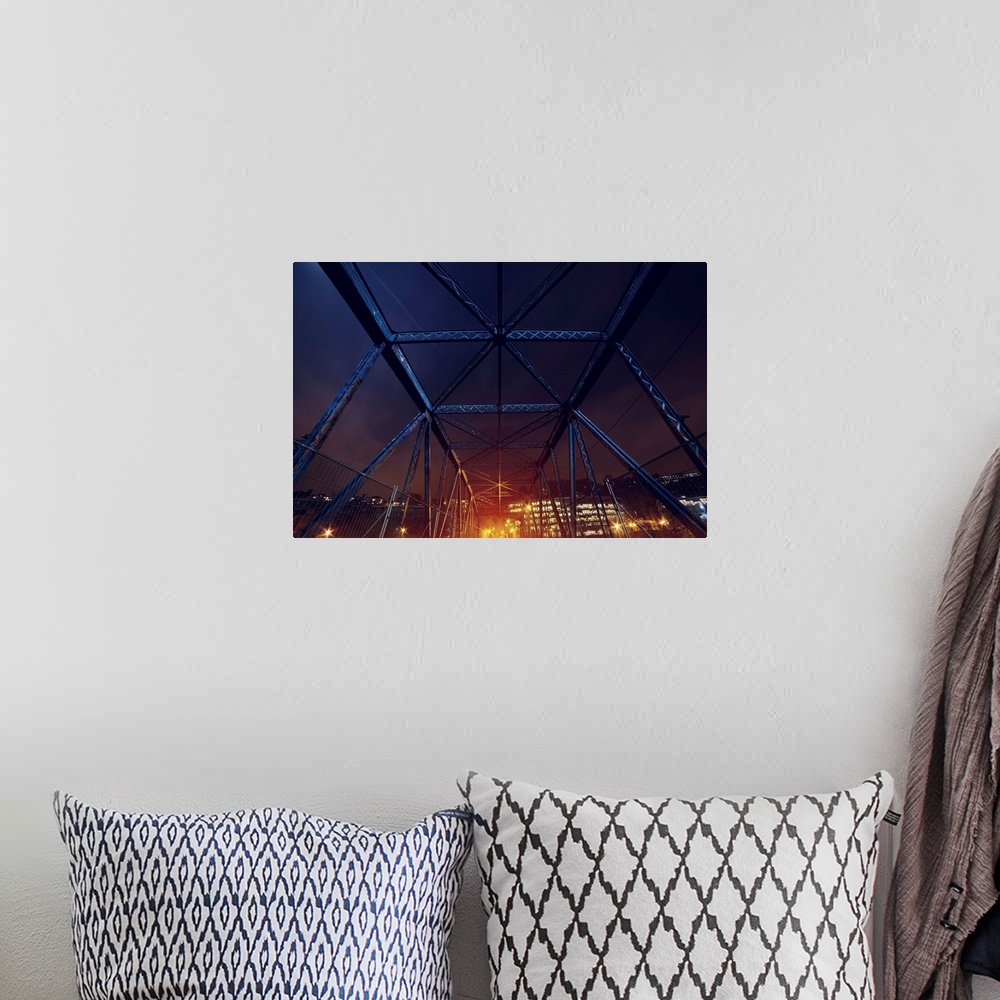 A bohemian room featuring An HDR photograph of an urban area seen through the frame of a bridge.