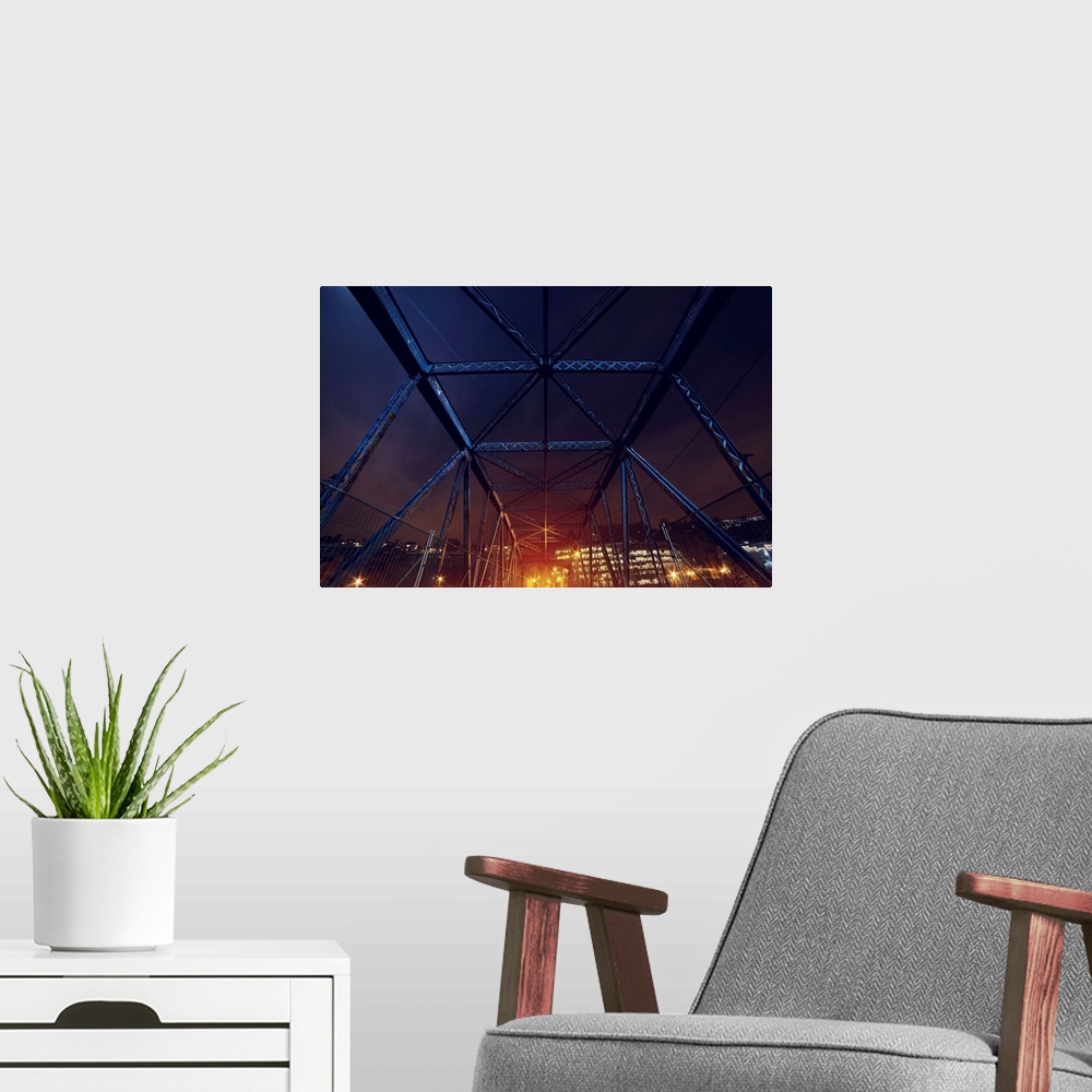 A modern room featuring An HDR photograph of an urban area seen through the frame of a bridge.