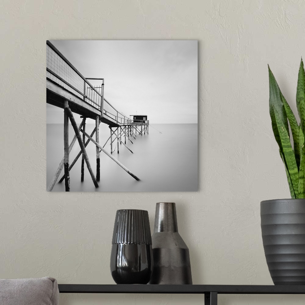 A modern room featuring Cabane, pier, water, fog, black and white photography