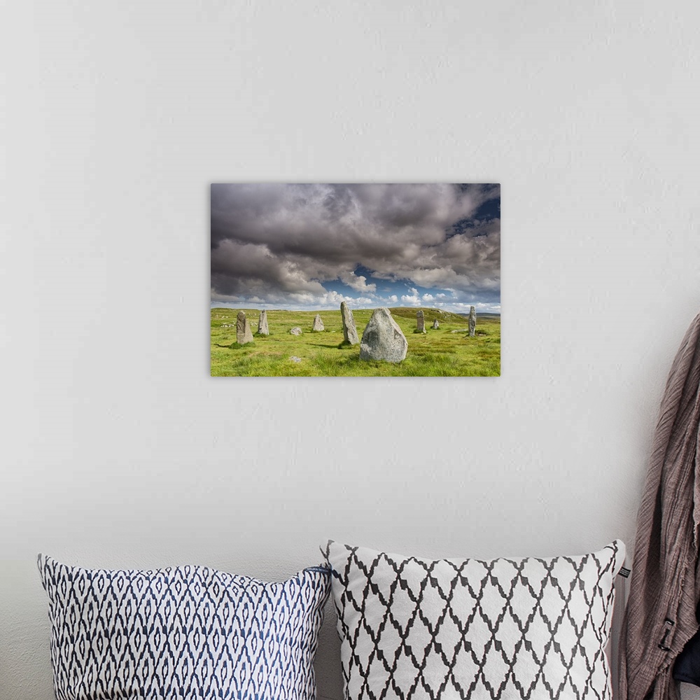 A bohemian room featuring A photograph of a group of monolith stones in Scotland.
