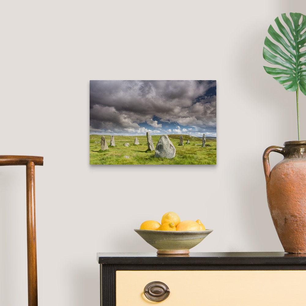 A traditional room featuring A photograph of a group of monolith stones in Scotland.