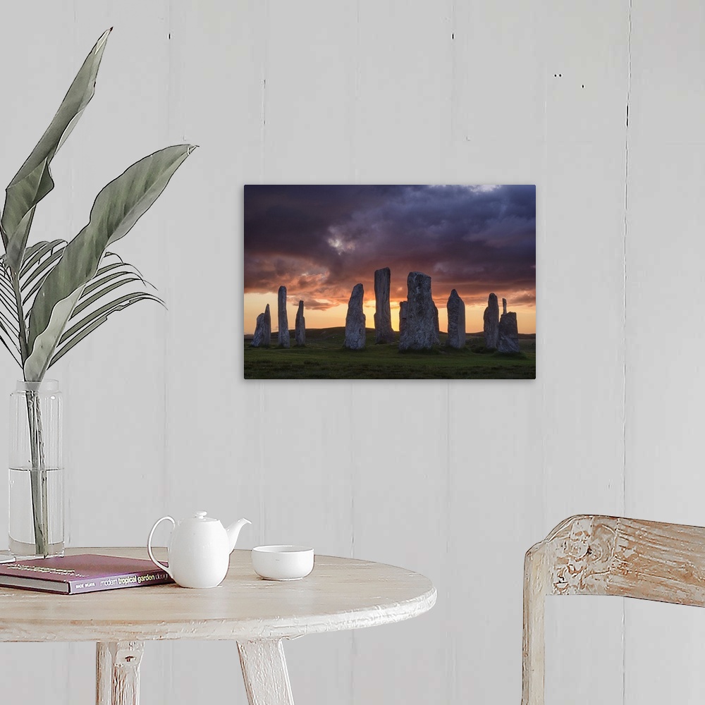 A farmhouse room featuring Photograph of ancient rock ruins in Scotland, under aggressive looking clouds.