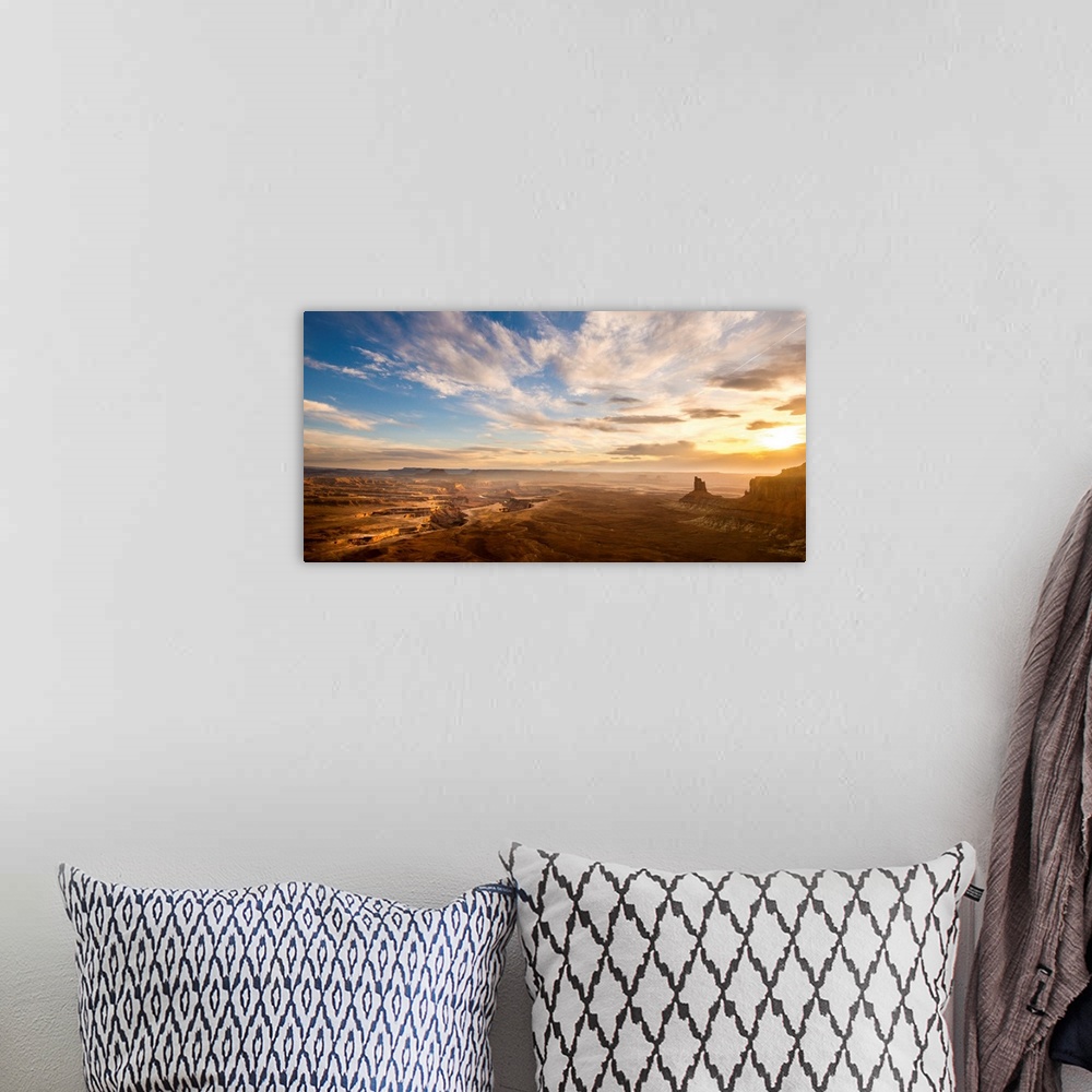 A bohemian room featuring Landscape photograph of canyons at sunrise.