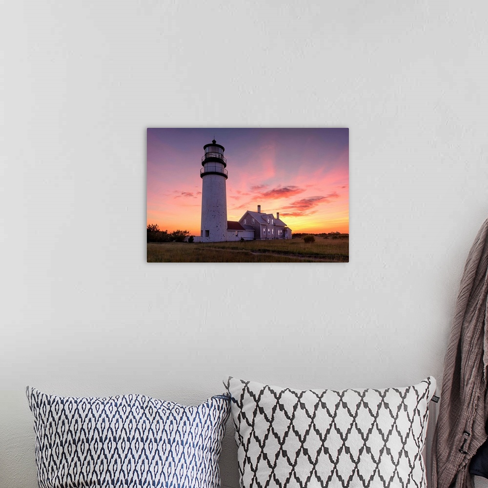 A bohemian room featuring Photograph of the Cape Cod Highland Lighthouse at sunset.