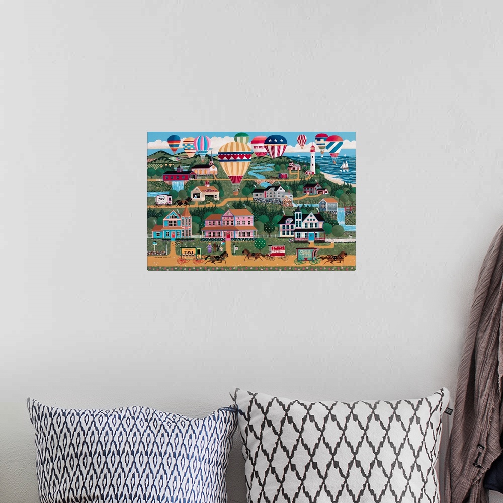 A bohemian room featuring Contemporary painting of an Americana countryside village scene during a balloon festival.