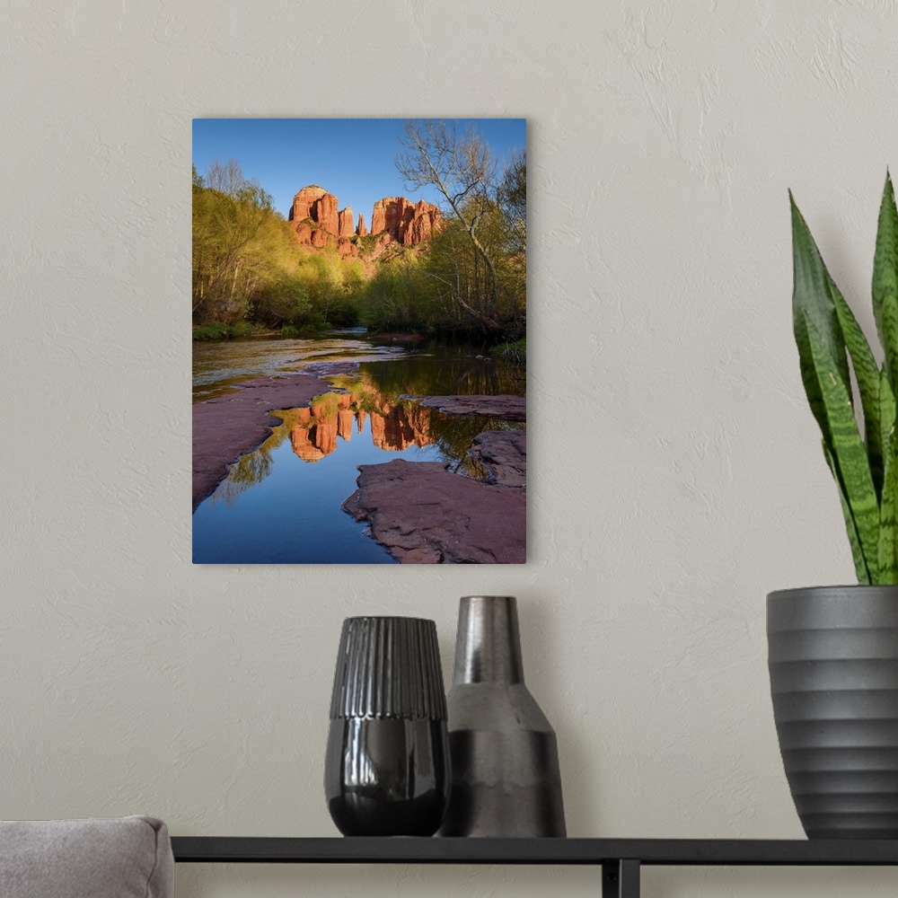 A modern room featuring Landscape photograph of Cathedral Rock reflecting into a low, rocky river, Sedona AZ.