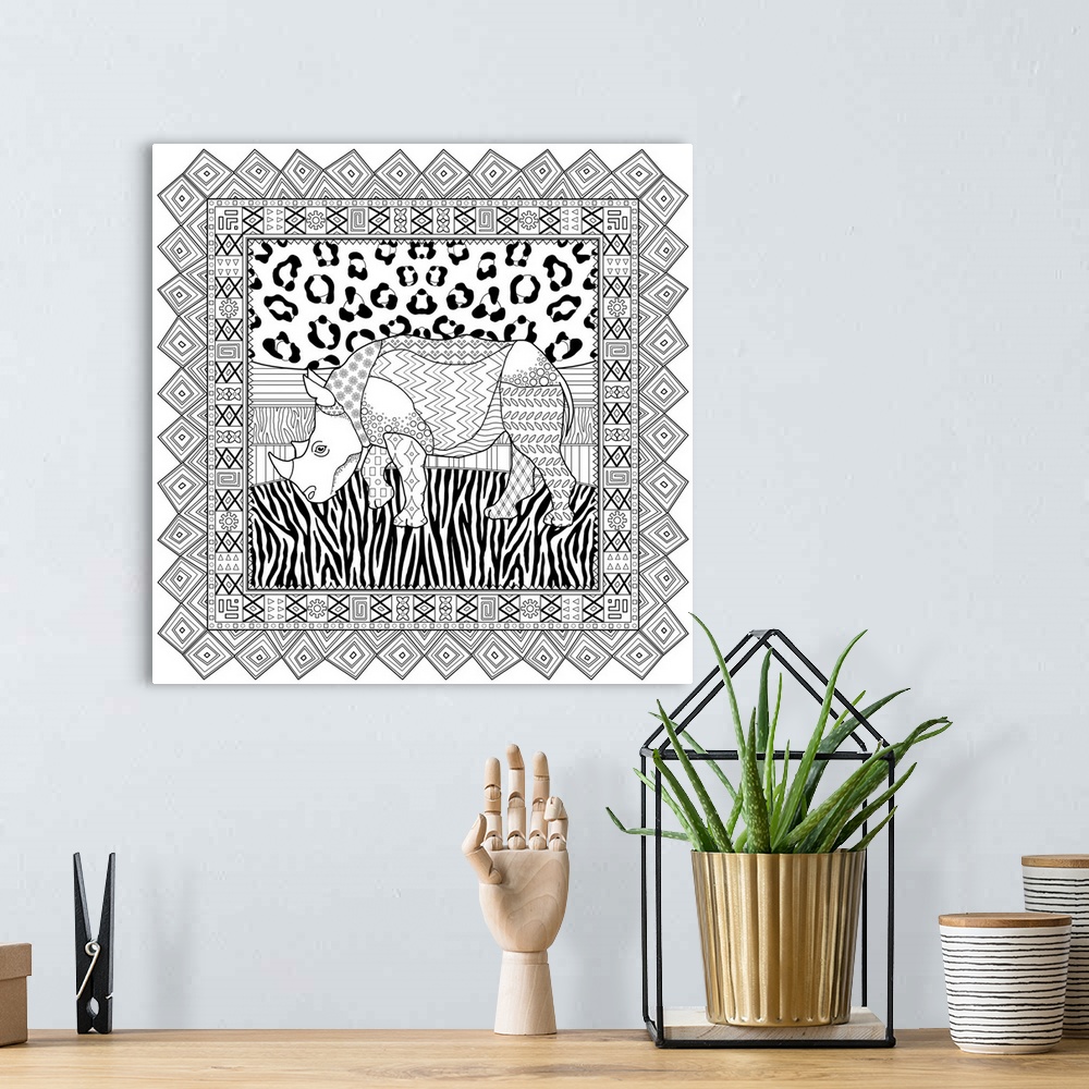A bohemian room featuring Black and white line art with an animal print background and a rhinoceros in the center inside a ...