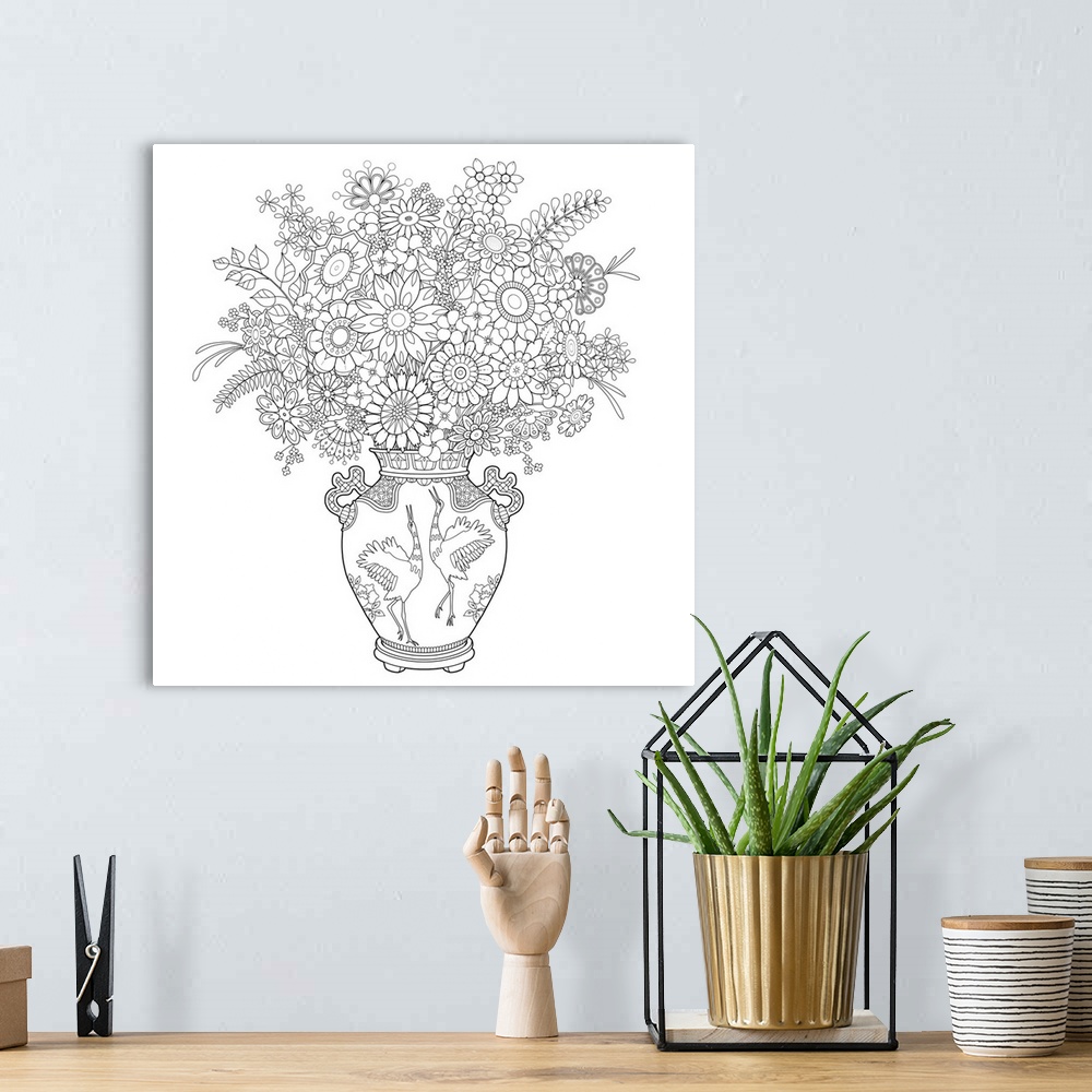 A bohemian room featuring Black and white line art of arranged flowers in a vase with two storks on it.