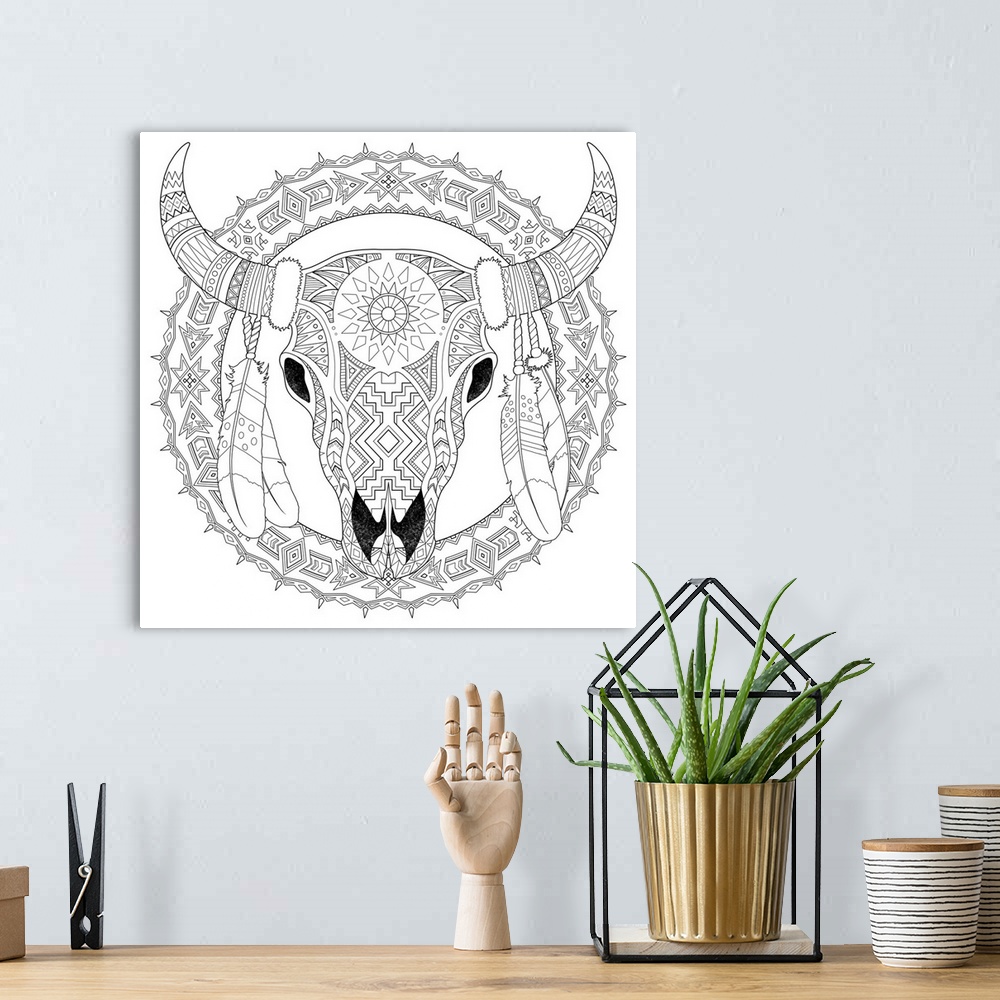 A bohemian room featuring Black and white line art of an intricately designed skull with horns and feathers.