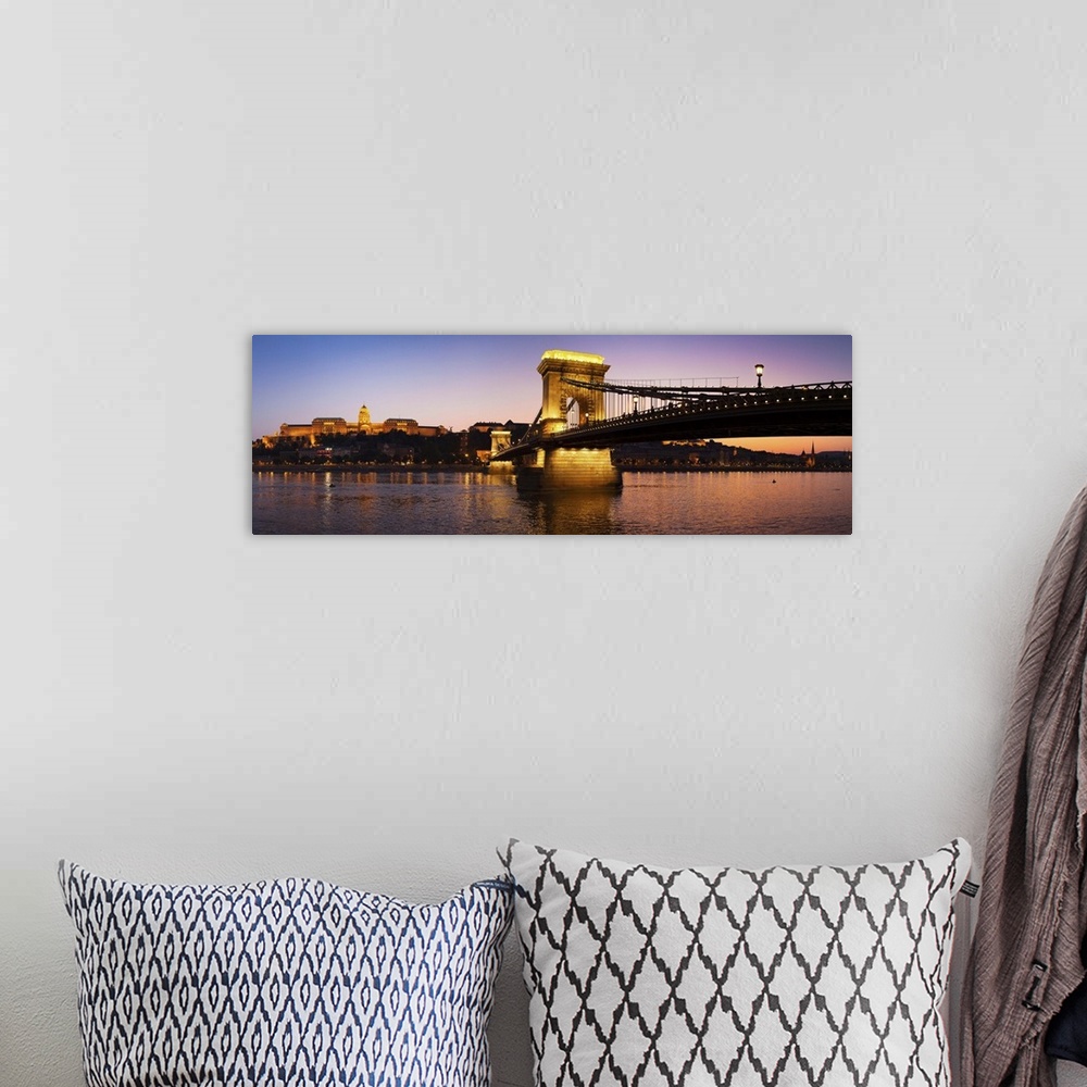 A bohemian room featuring Panoramic photograph of the Chain Bridge in Budapest at dusk.
