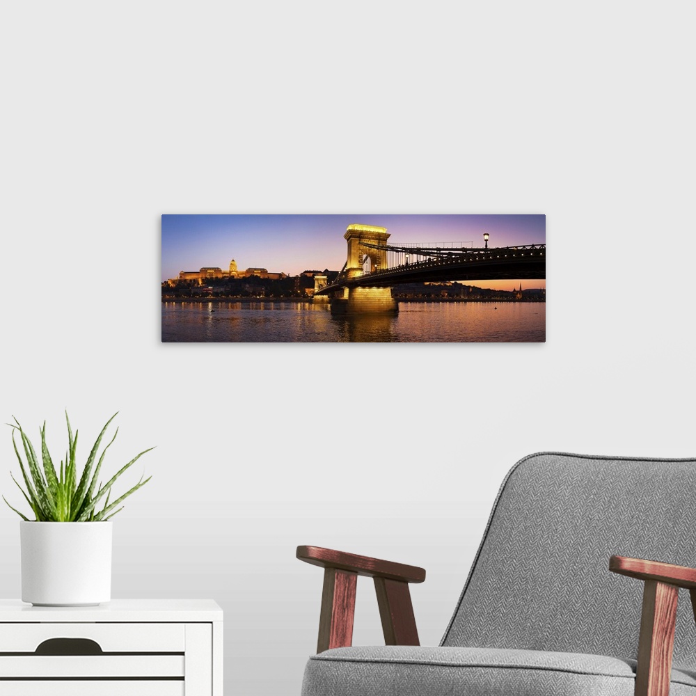 A modern room featuring Panoramic photograph of the Chain Bridge in Budapest at dusk.