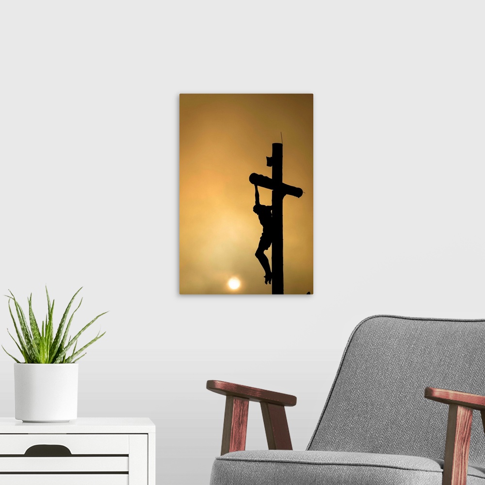 A modern room featuring Silhouette of Christ on the cross at sunset.