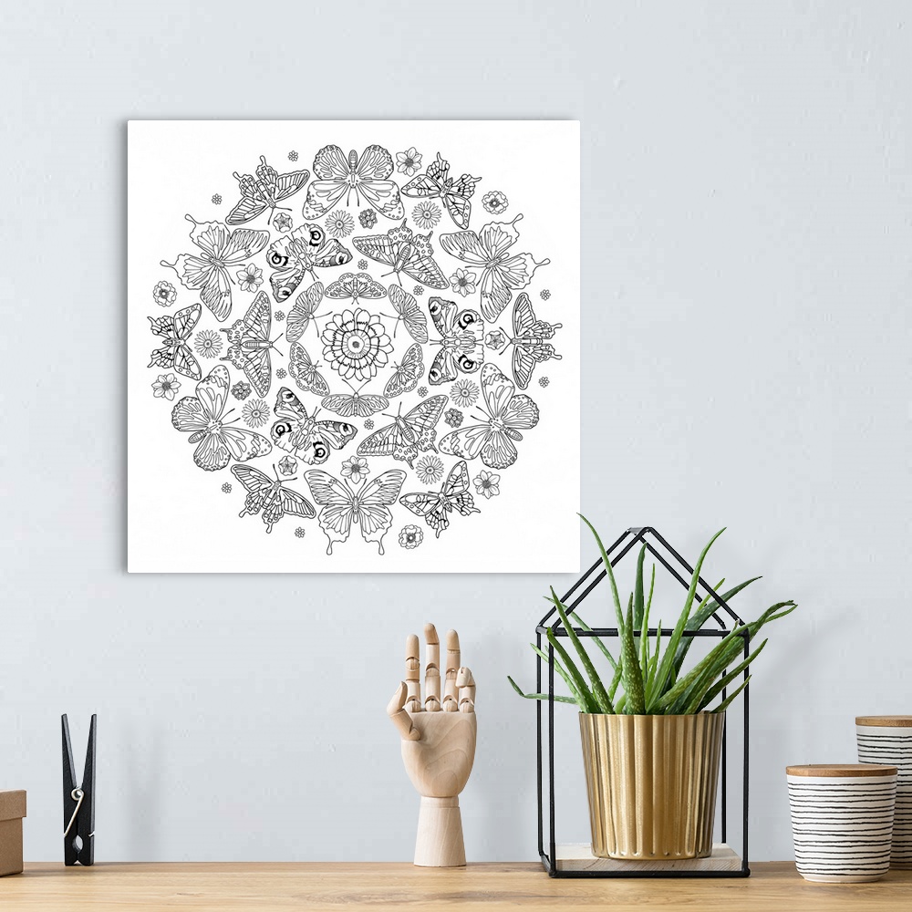 A bohemian room featuring Black and white line art of an intricately designed mandala made out of butterflies and flowers.