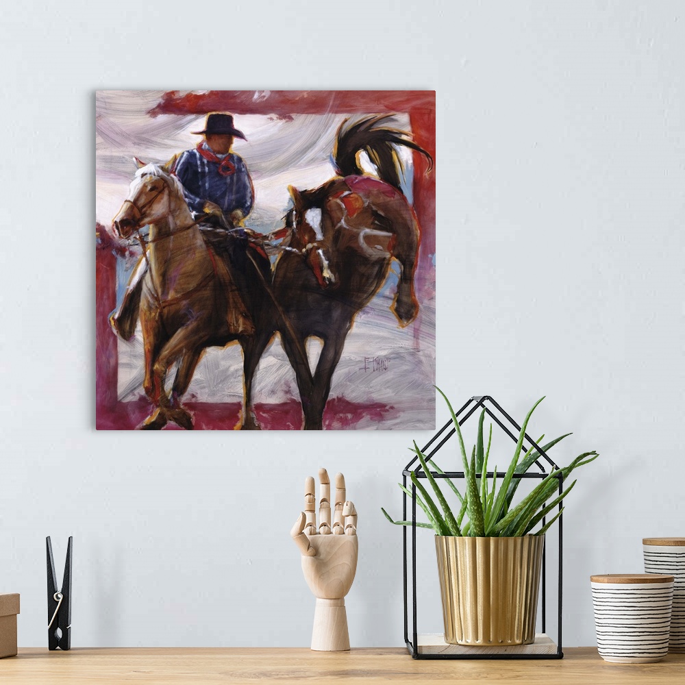 A bohemian room featuring Contemporary western theme painting of a cowboy on horseback, lassoing another horse.