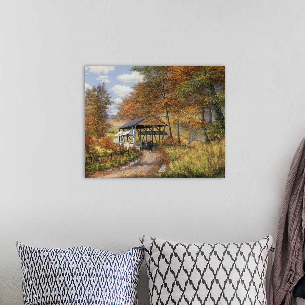 A bohemian room featuring Covered bridge on dirt road through autumn woods.