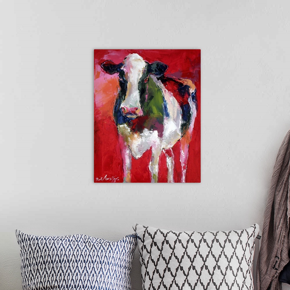 A bohemian room featuring Contemporary vibrant colorful painting of a cow against a red background.