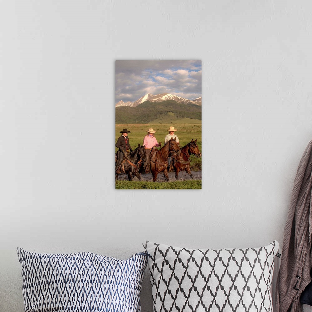 A bohemian room featuring Photograph of three cowgirls on horseback crossing a river.