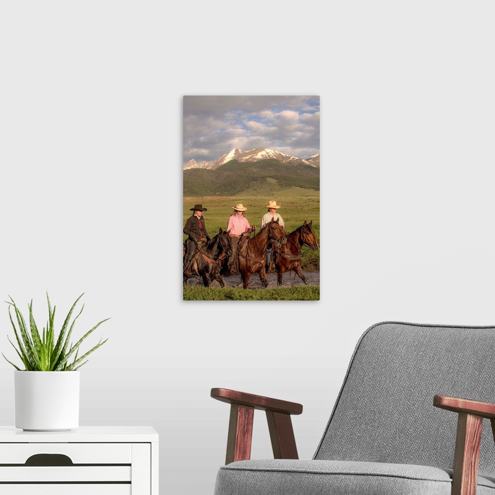 A modern room featuring Photograph of three cowgirls on horseback crossing a river.