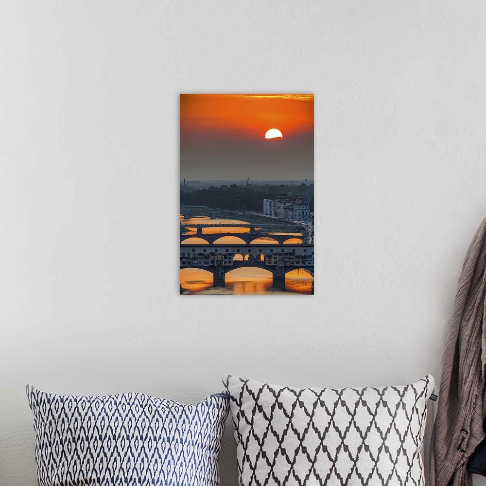 A bohemian room featuring Orange sky above the river and bridges, color photography