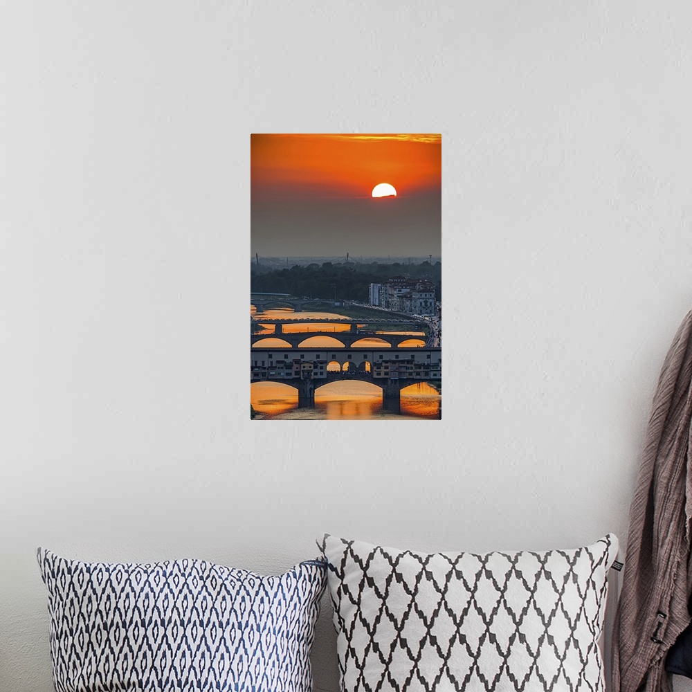 A bohemian room featuring Orange sky above the river and bridges, color photography