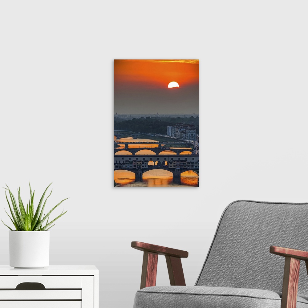 A modern room featuring Orange sky above the river and bridges, color photography